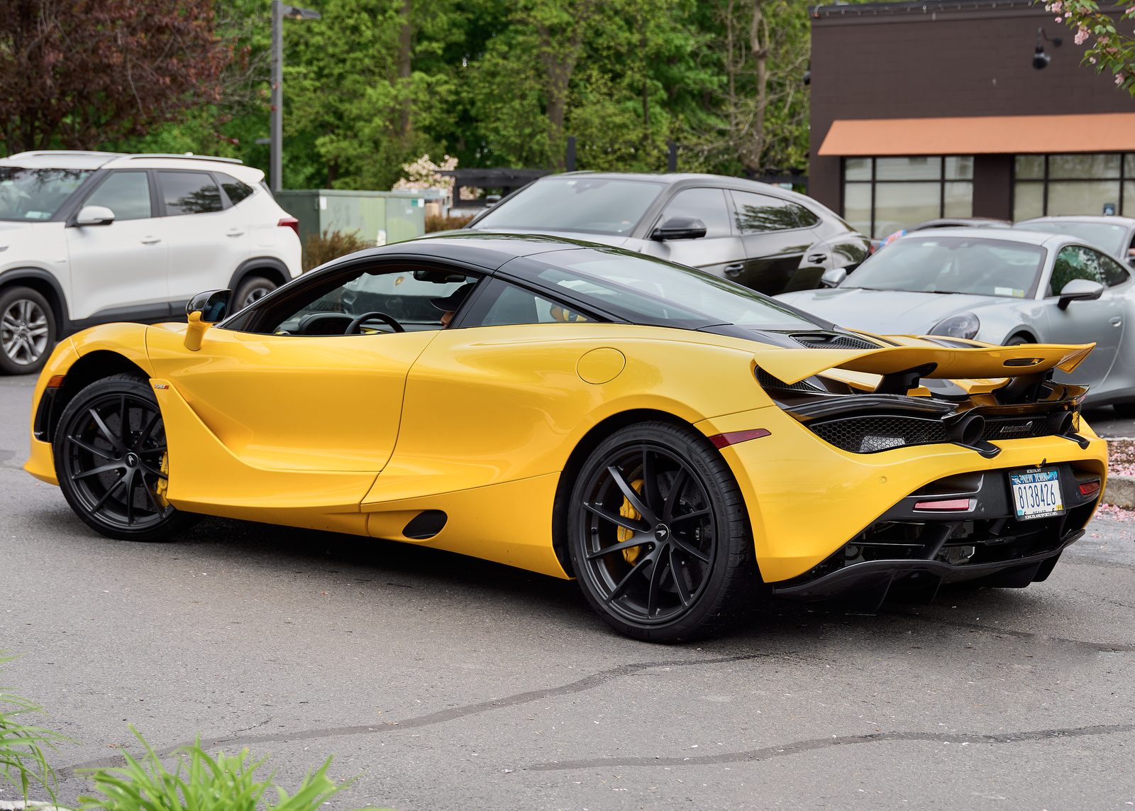 A yellow McLaren in the town car park