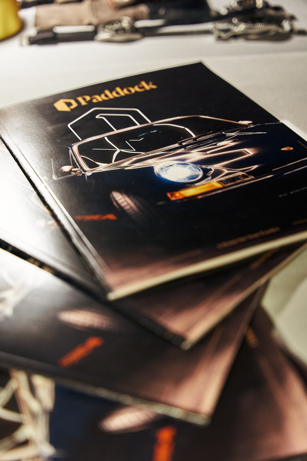 Copies of the Paddock magazine on the table